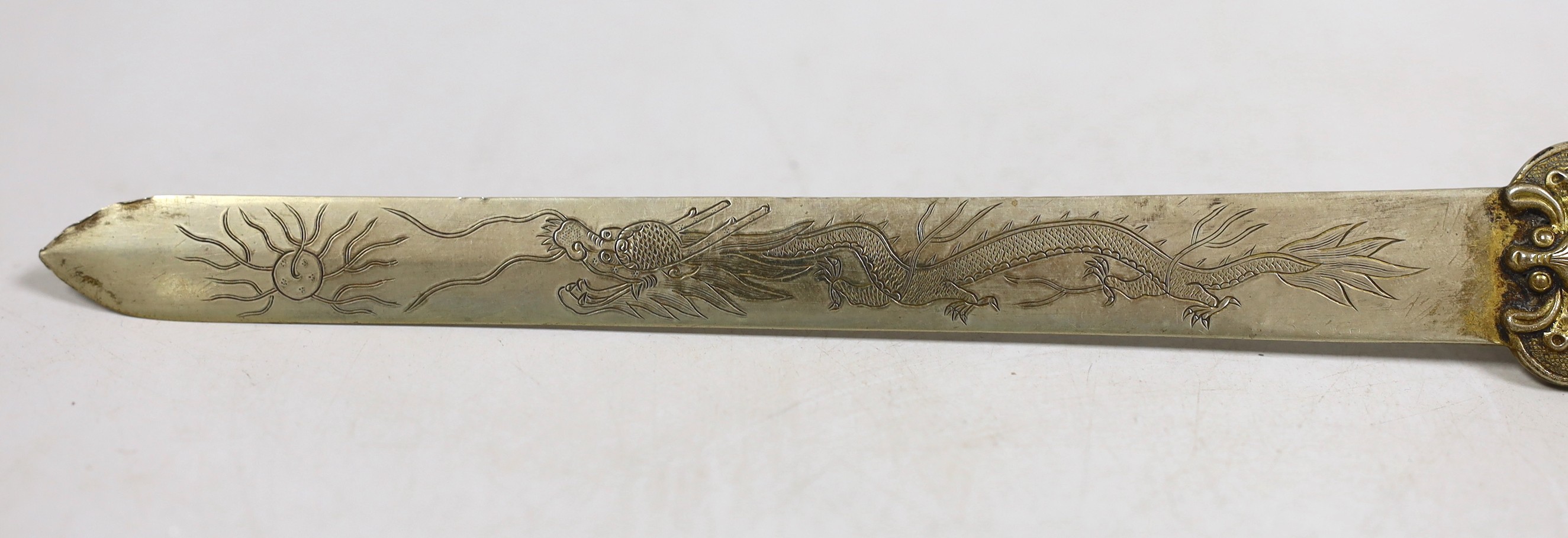 A Chinese celadon jade belt hook handled paperknife, the 19th century belt hook 8.2 cm long, total length 26.5 cm